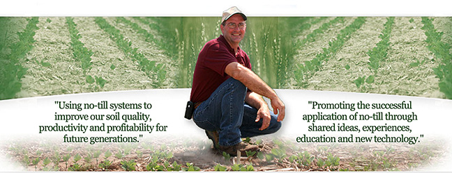 Farmer with tilled fields behind him